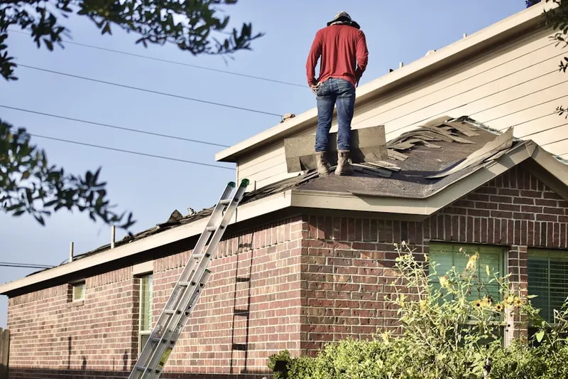 Professional roofer working on a residential roof in Klines Corner